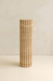 A beige travertine decorative tray with a wave pattern, displayed on a plain background.